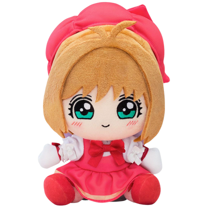 Plush toy of a character with blonde hair and green eyes, wearing a red outfit on a white background