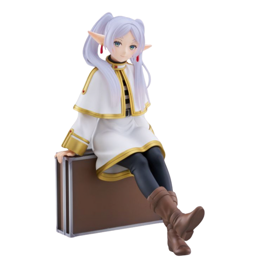Anime character figurine sitting on a suitcase with a white background