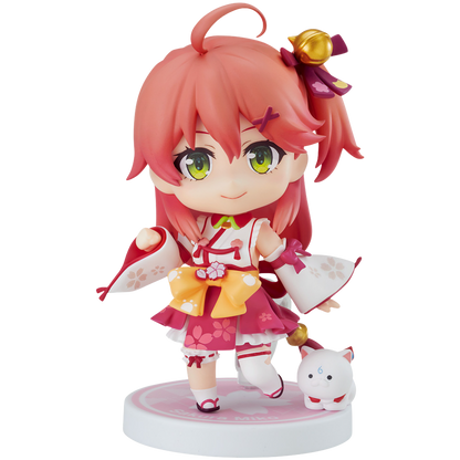 Anime character figurine with pink hair and green eyes on a white background