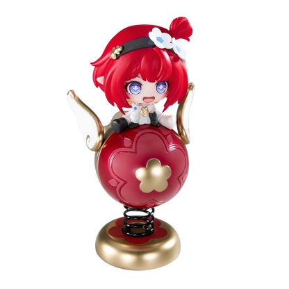 A chibi-style collectible figure with bright red hair and purple eyes, seated on a red heart-shaped spring base with gold accents and white wings, isolated on a black background.