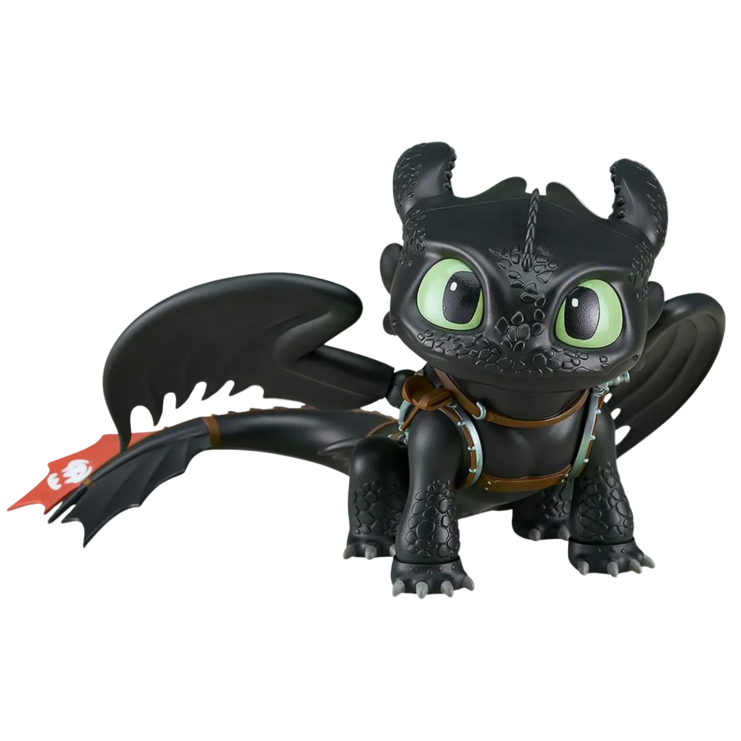 Black dragon toy figure with green eyes on a white background
