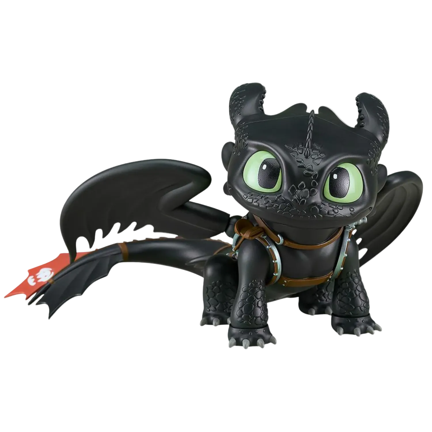 Black dragon toy figure with green eyes on a white background