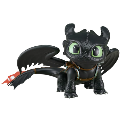 Black dragon toy figure with green eyes on a white background