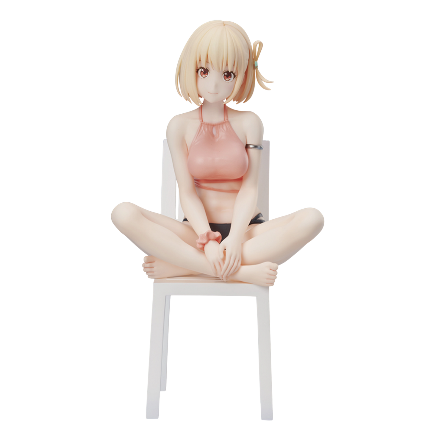Anime character figurine sitting on a chair against a white background