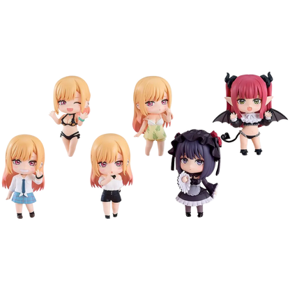 Set of five small figurines with different hairstyles and outfits on a white background