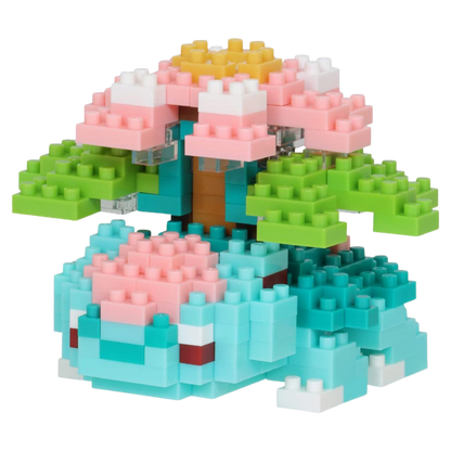 Toy building block set shaped like a tree with pink flowers and green leaves on a white background