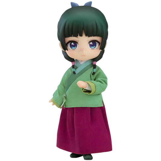 Toy figure of a character in green top and purple skirt on a white background