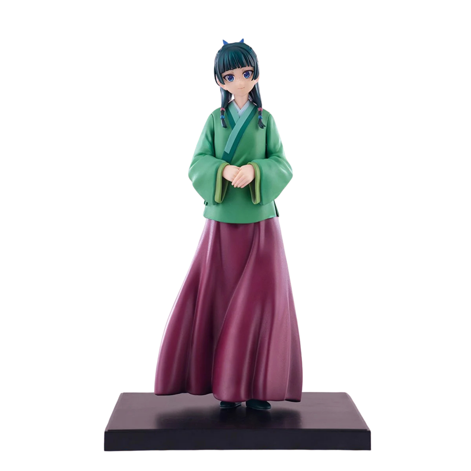 Figurine of a character in green top and purple skirt on a white background