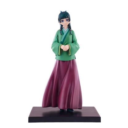 Figurine of a character in green top and purple skirt on a white background