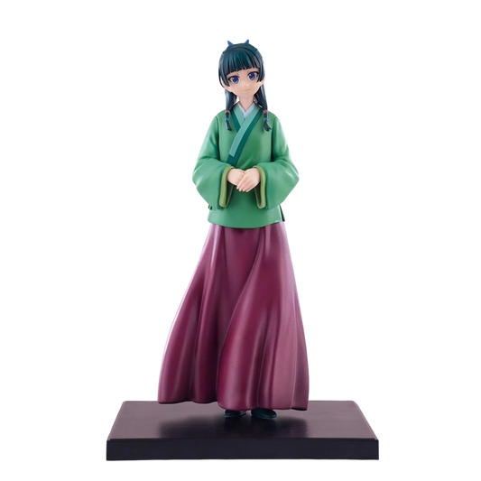 Figurine of a character in green top and purple skirt on a white background