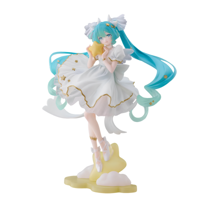 A collectible figurine of Hatsune Miku in a white dress with gold accents, standing on a yellow cloud-like base against a solid white background.