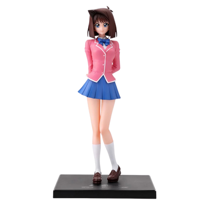 Figure of a character in a pink jacket and blue skirt on a white background